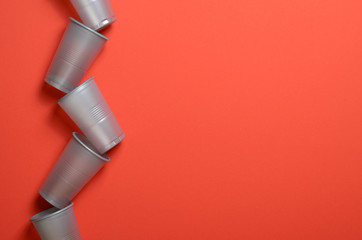 Grey Plastic Cups on Bright Orange Background, , Food Concept