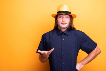 Confused male with long hair and cowboy hat