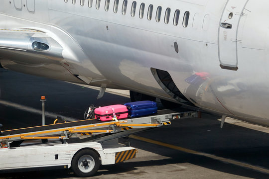 Loading suitcases of tourists in the plane