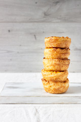 Traditional portuguese egg tart (Pasteis de nata, Pasteis de Belem) on a white wooden cutting board