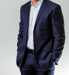 Close-up cropped Caucasian hands and arms of businessman in a suit