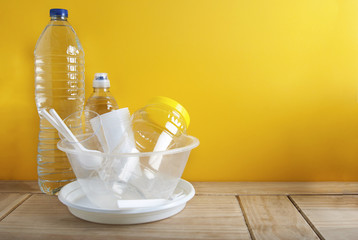 No Plastic Recycle Concept Whitel Plastic Dishes Plates Cups Spoon Isoalted Yellow background Copy Space
