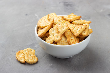 Dry salty cracker cookies on gray stone background.