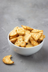 Dry salty cracker cookies on gray stone background.