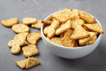 Dry salty cracker cookies on gray stone background.