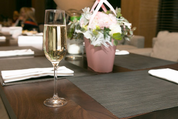 a glass of champagne on the table