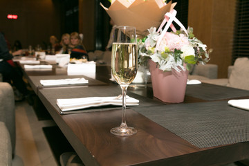 a glass of champagne on the table