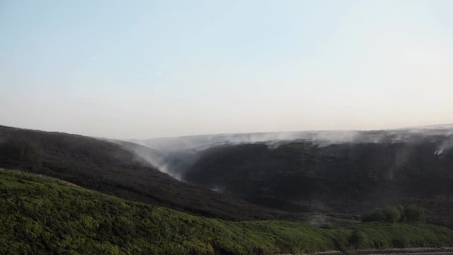 UK June 2018 - Time lapse of a smouldering and smoking moorland following a wildfire.
