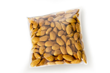 Almonds packed in plastic bag isolated on white background
