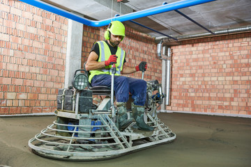 Concrete flooring. using ride-on power trowelling machine for surface floating