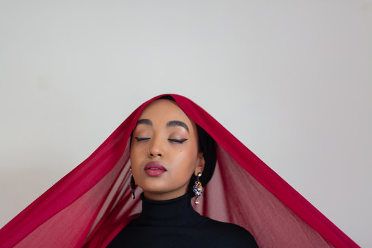 Young woman wearing a red hijab