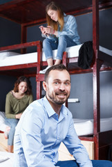 Ssmiling male traveller in hostel