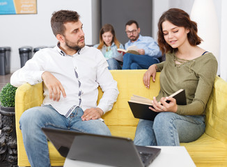 Fototapeta premium Young people with laptop and book