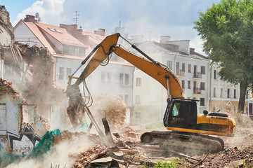 Fototapeta premium excavator crasher machine at demolition on construction site