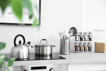 Modern kitchen interior with new furniture and different utensils