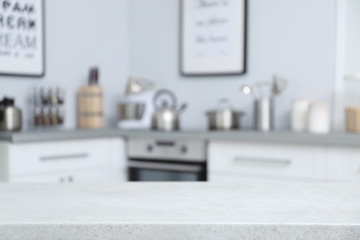 Empty table and blurred view of kitchen interior