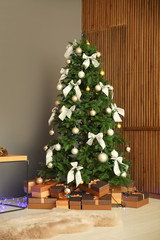 Beautiful Christmas tree and gift boxes indoors
