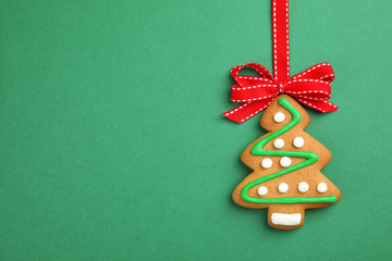 Tasty homemade Christmas cookie on color background