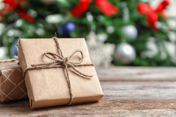 Beautiful gift boxes and blurred Christmas tree on background