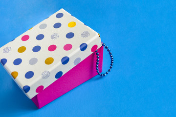 Blue beads in a colored box. New Year decoration.