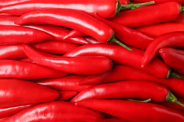 Ripe hot chili peppers as background, closeup