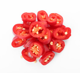 Pile of cut chili peppers on white background, top view