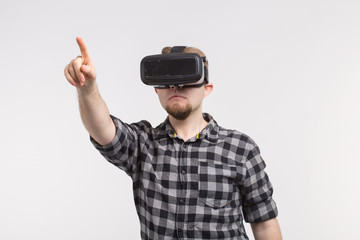 Man wearing virtual reality glasses raising his hand