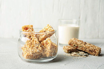 Jar with different homemade grain cereal bars on table. Healthy snack