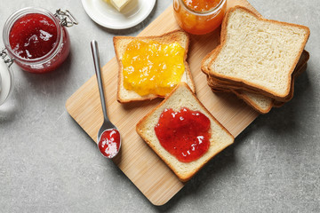 Toast bread with jams on table, top view