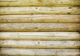 Blocks of wood stacked as wall. Wooden background with light colors. Pattern, texture.