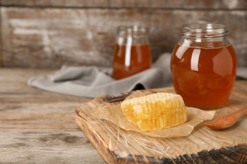 Composition with tasty fresh honey on wooden board
