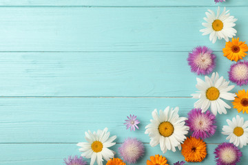 Obraz premium Flat lay composition with wild flowers on wooden background