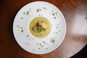 Fresh soup with ham in a plate