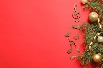 Flat lay composition with decorations and  notes on color background. Christmas music concept
