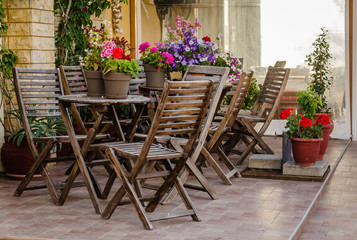 Fototapeta na wymiar Chairs in the garden restaurant in Leptokaria, Greece 