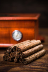 Fototapeta na wymiar Cuban cigars with humidor in background