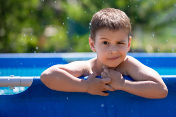 Portrait of a smiling boy. Child in the pool