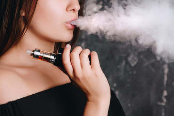 Gentle girl vaping an electronic cigarette
