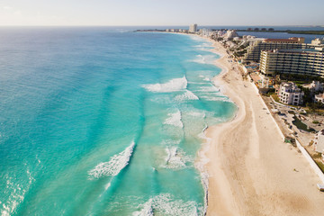 Cancun beach panorama aerial view. Aerial view of Caribbean Sea beach. Zona hotelera top view.  Beauty nature landscape with tropical beach. Caribbean seaside beach with turquoise water and big wave - obrazy, fototapety, plakaty