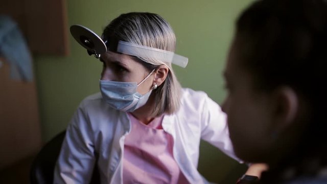 Preventive inspection at child reception at ENT doctor, medical examination of kid by doctor