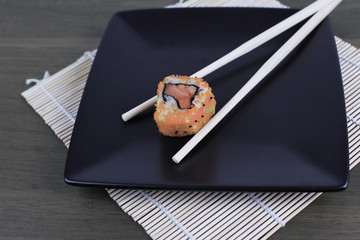 close-up of sushi and chopsticks on a wooden table