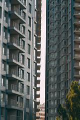 Fototapeta premium Bottom view of modern skyscrapers in business district against blue sky