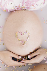 Obraz na płótnie Canvas belly of a pregnant woman with a heart
