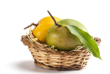 Mangoes in cane basket isolated on white background