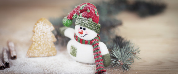 Christmas Cup and a toy snowman on wooden background