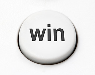 A white round button switch - win, close up. Control mechanical key for select idea of user on control device.