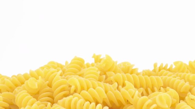 Italian fusilli pasta rotating on white background, copy-space (loopable)