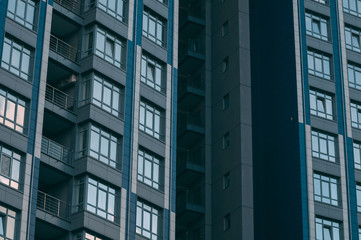 Bottom view of modern skyscrapers in business district against blue sky.