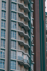 Fototapeta premium Bottom view of modern skyscrapers in business district against blue sky.