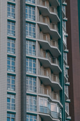 Bottom view of modern skyscrapers in business district against blue sky.